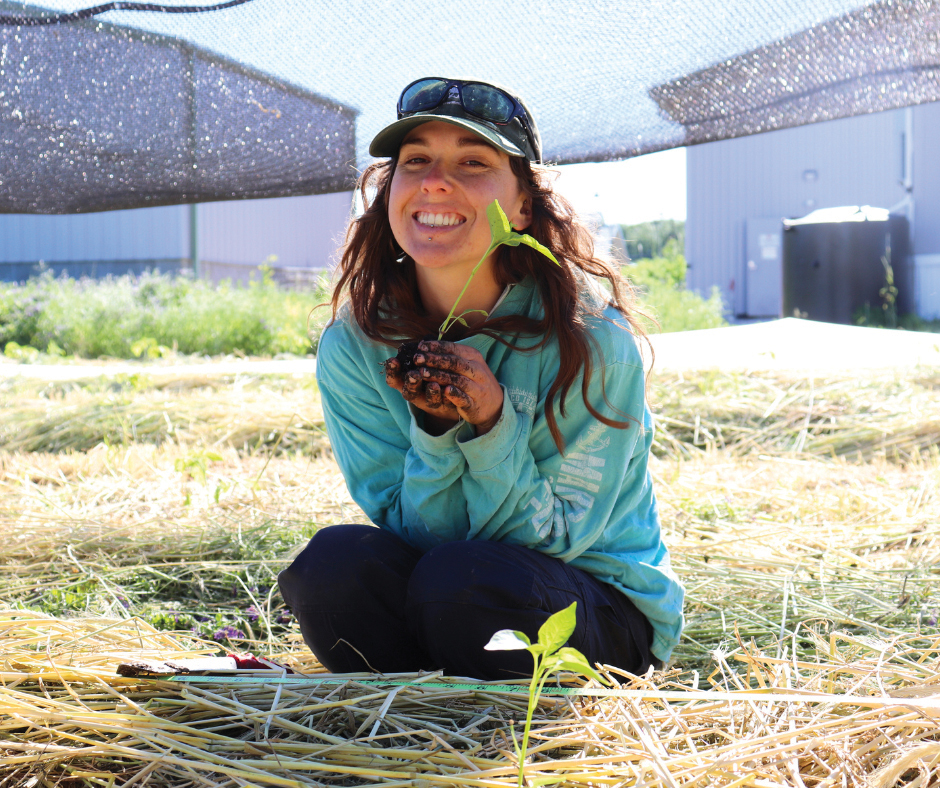 Woman Smiling With Plant Ccua