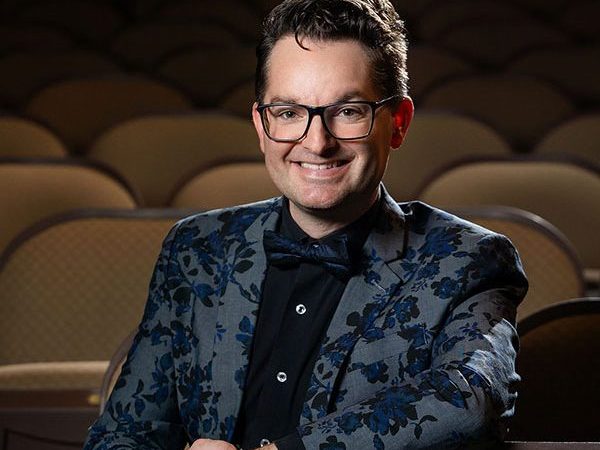 Trent Rash poses for a photograph while seated in the historic Missouri Theatre in Columbia, Missouri.