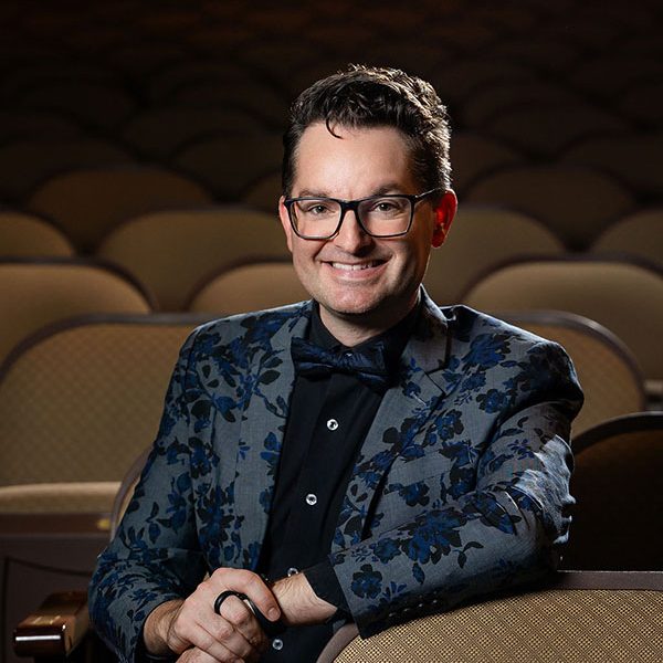 Trent Rash poses for a photograph while seated in the historic Missouri Theatre in Columbia, Missouri.