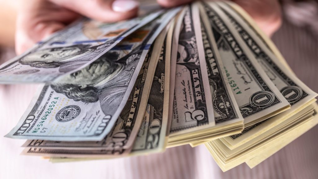 holding money out in a fan