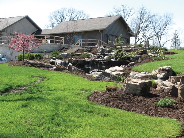 home exterior, large rocks in yard