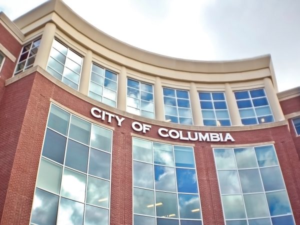 Front of the city hall in Columbia, Missouri, USA, with blue sky reflecting in the windows