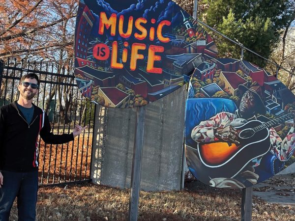 David Spear with a guitar pick sculpture