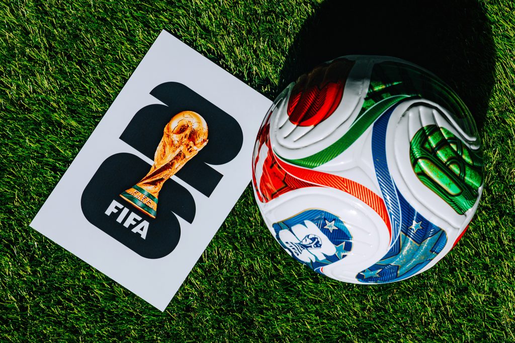 Official FIFA World Cup 2026 Match Ball on Pitch and official logo